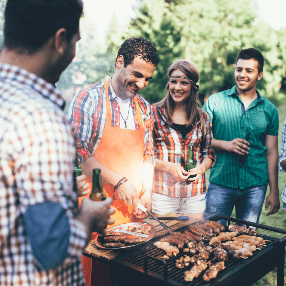 People laughing as they are cooking a gourmet bbq