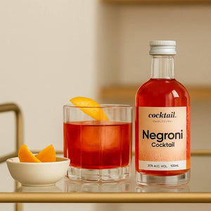 Negroni 100ml next to glass garnished with with orange