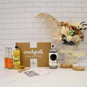 Gin Subscription box in the kitchen with ingredients and 2 Gin and Ginger Beer cocktails | Cocktail Collective