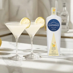 two lemon drop martini cocktails next to a 700ml scapegrace yuxu vodka