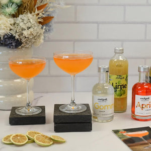2 Toreador Cocktails next to Gomme Syrup, Lime Juice and Apricot