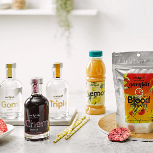 Cocktail Essentials showing Gomme Syrup, Cherry Liqueur, Triple Sec, Blood Orange Cocktail Garnish and Fresh Lemon Juice.