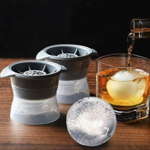Spherical Ice Moulds with ice and a whiskey being poured