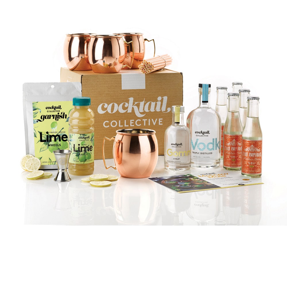 A gift set with the Moscow Mule Cocktail Kit with Vodka, Ginger Beer, Lime Juice, Gomme Syrup and four copper mugs