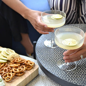 Girl'shands with gimlet cocktails