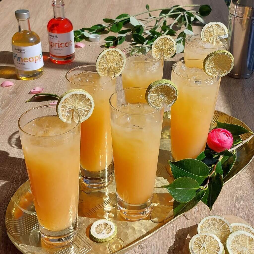 Tray of Hotel Nacional cocktails with lime wheel garnish