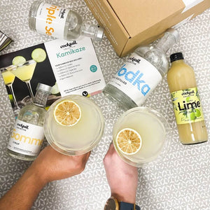 Cocktail Collective bottles on table with kamikaze cocktail in glass