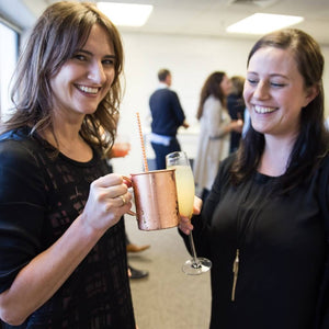 Women saying cheers with cocktails in hand