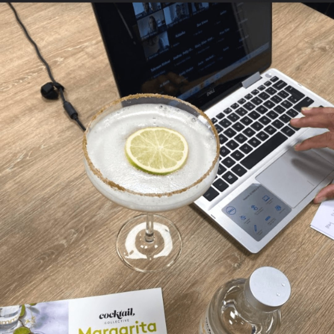 Margarita cocktail next to laptop