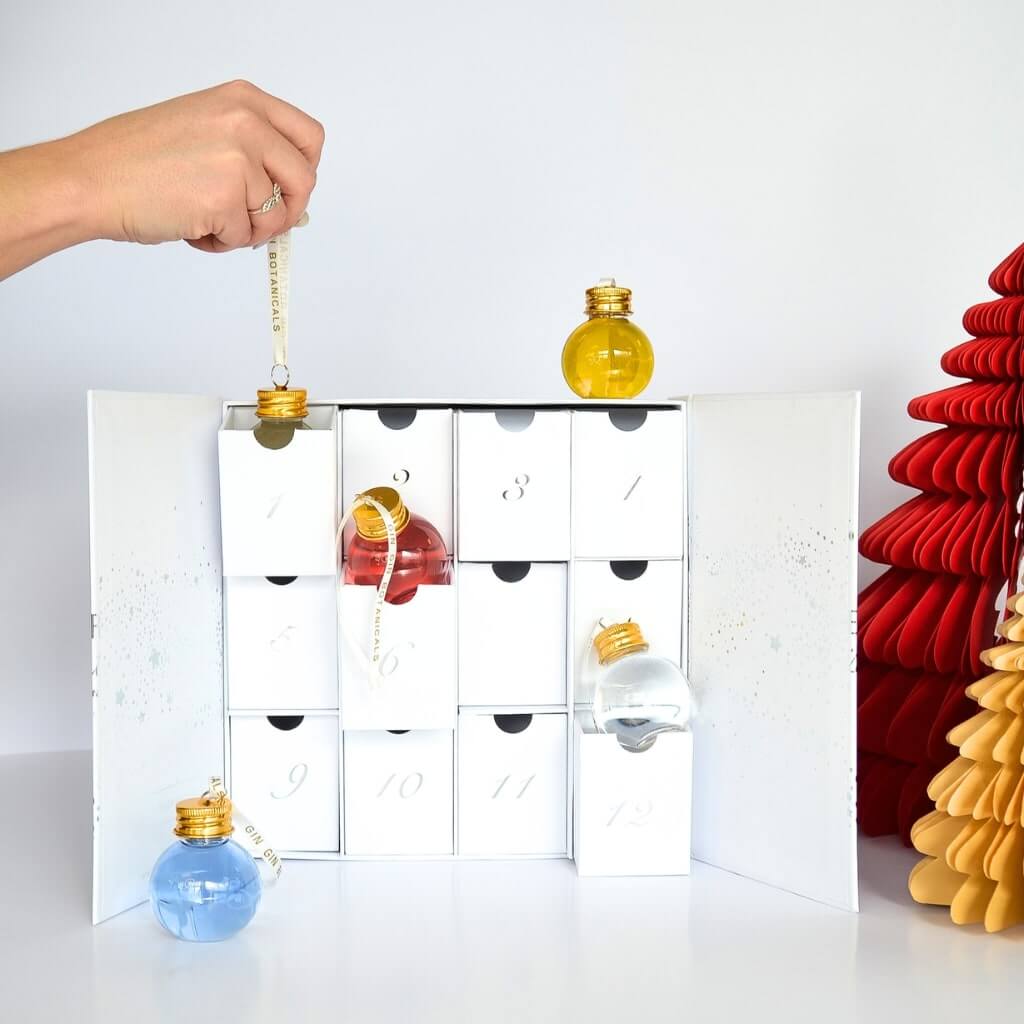 Woman's hand picking bauble from 12-day Gin Bauble Advent Calendar