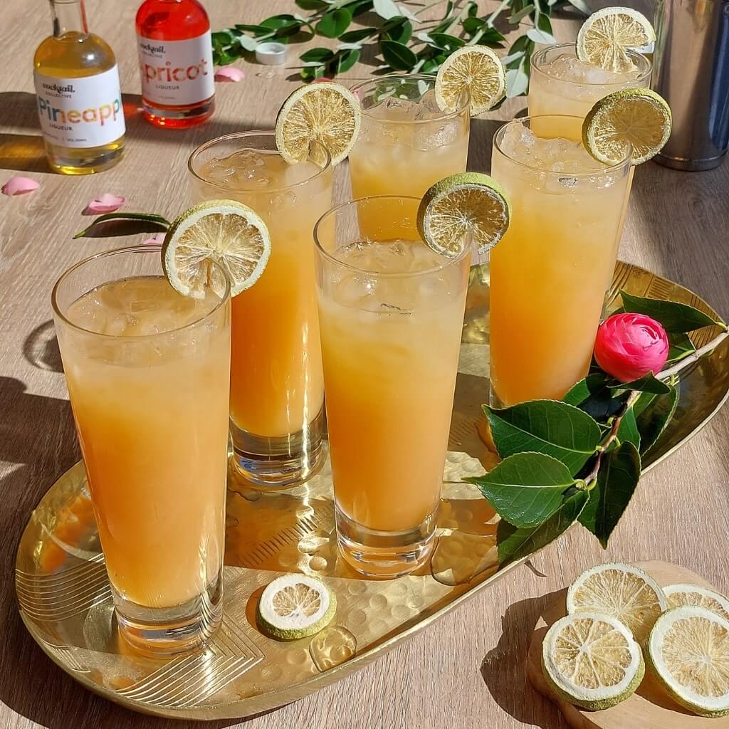 Cocktail Collective's Hotel Nacional cocktails on tray with lime wheel garnish