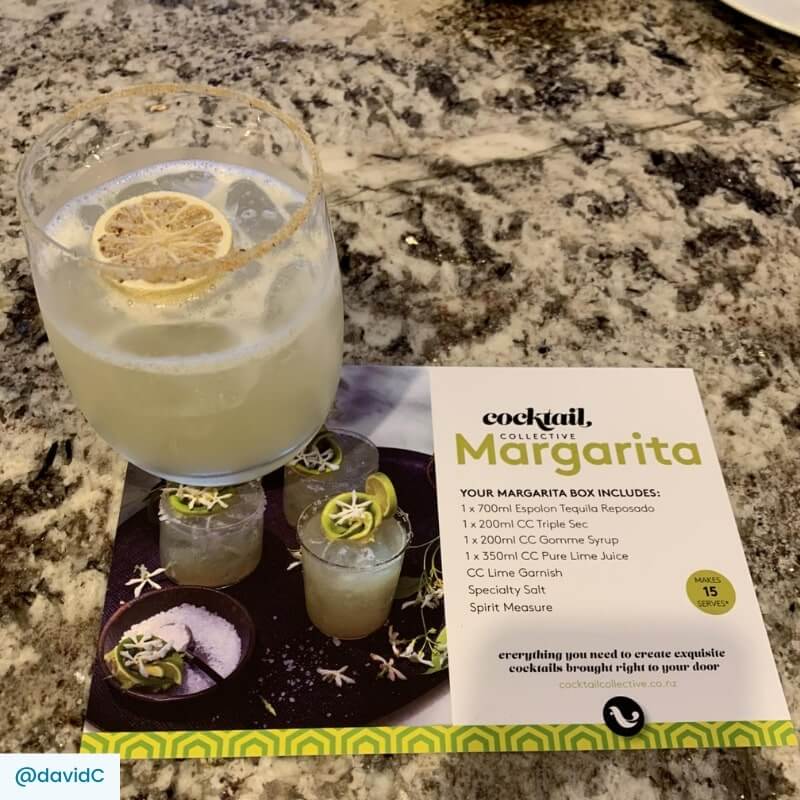 Magarita cocktail in tumbler with salted rim, lime wheekl garnish and recipe card