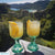 Two Lemon Drop Martini cocktails with lemon wedge garnish on a balcony with scenic background view 