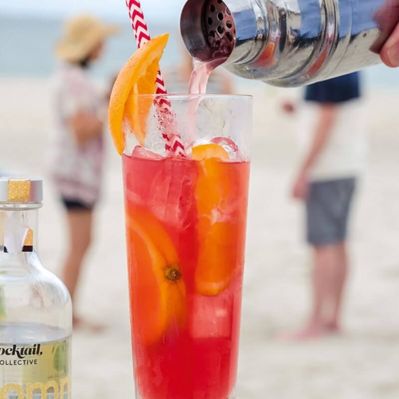 Pouring a Bechcomber cocktail on the beach