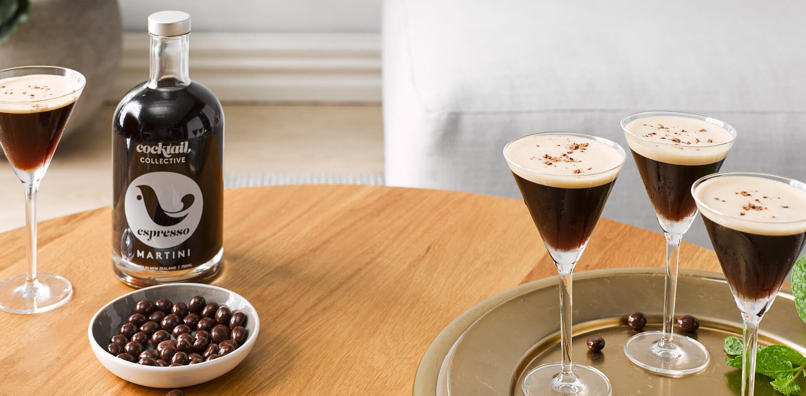 Espresso Martini Cocktails in martini glasses displayed on a table with chocolate coated coffeebeans