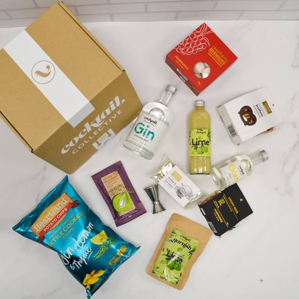 Gimlet Cocktail Box flat lay with lime wheel garnish and snacks