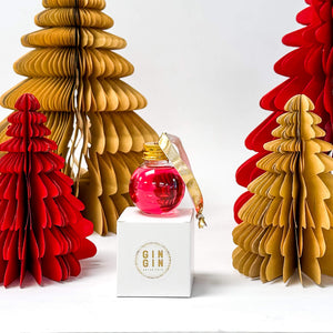 Pink Gin filled bauble with gold ribbon sitting white box | Cocktail Collective
