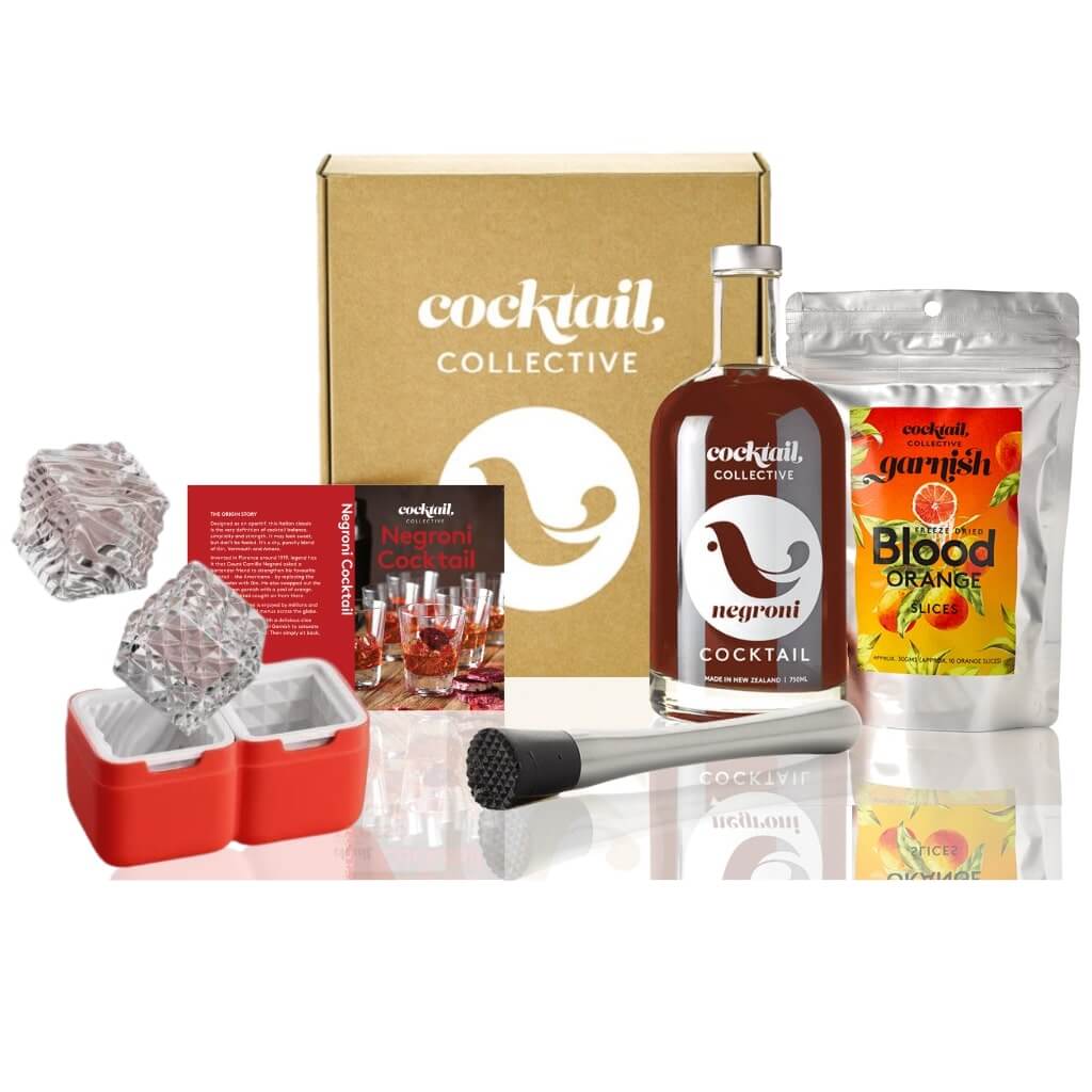 The Ultimate Negroni Cocktail Gift Set with a Cocktail Collective gift box, a premixed bottle of Negroni Cocktail, a packet of Blood Red Orange Garnish, a Modern Muddler and 2 Luxe Zoku Ice Moulds