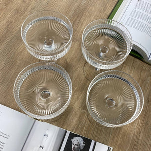 Ribbed cocktail coupe glasses filled with water