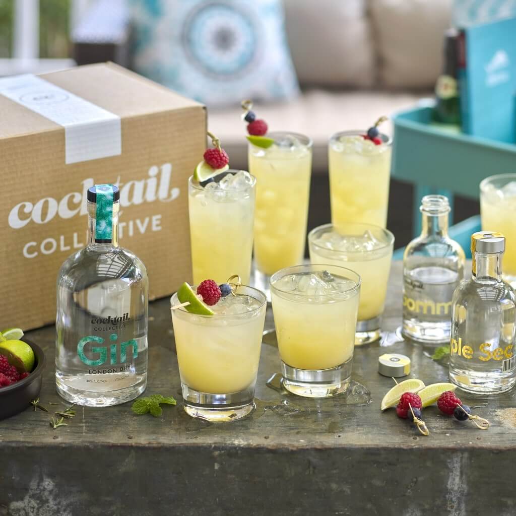 Gin based cocktails with garnish on outdoor table
