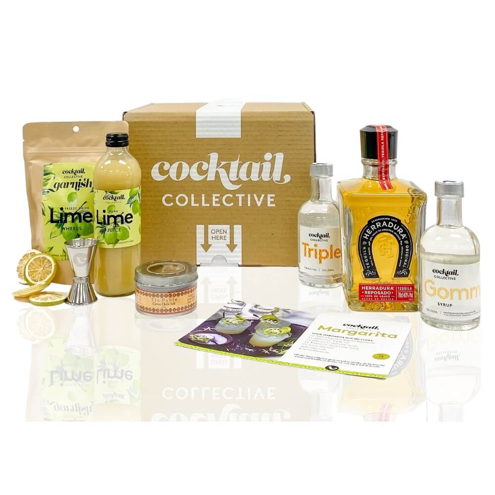 Deluxe Margarita Cocktail in coupe glass with lime wheel garnish, displayed on a bench with jewellry beside it