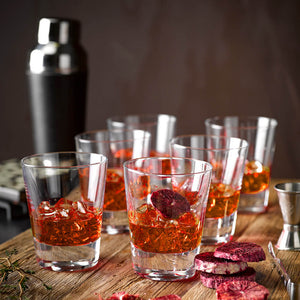 Six Negroni cocktails garnished with freeze-dried Blood Orange slices, served in tumblers from Schott Zwiesel are sitting on a rustic wooden tray | Cocktail Collective