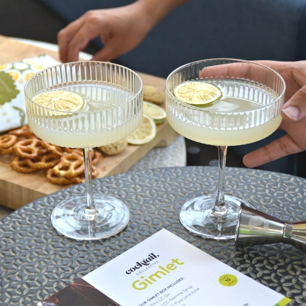 Gimlet Cocktails in coupe glasses with lime wheel garnish