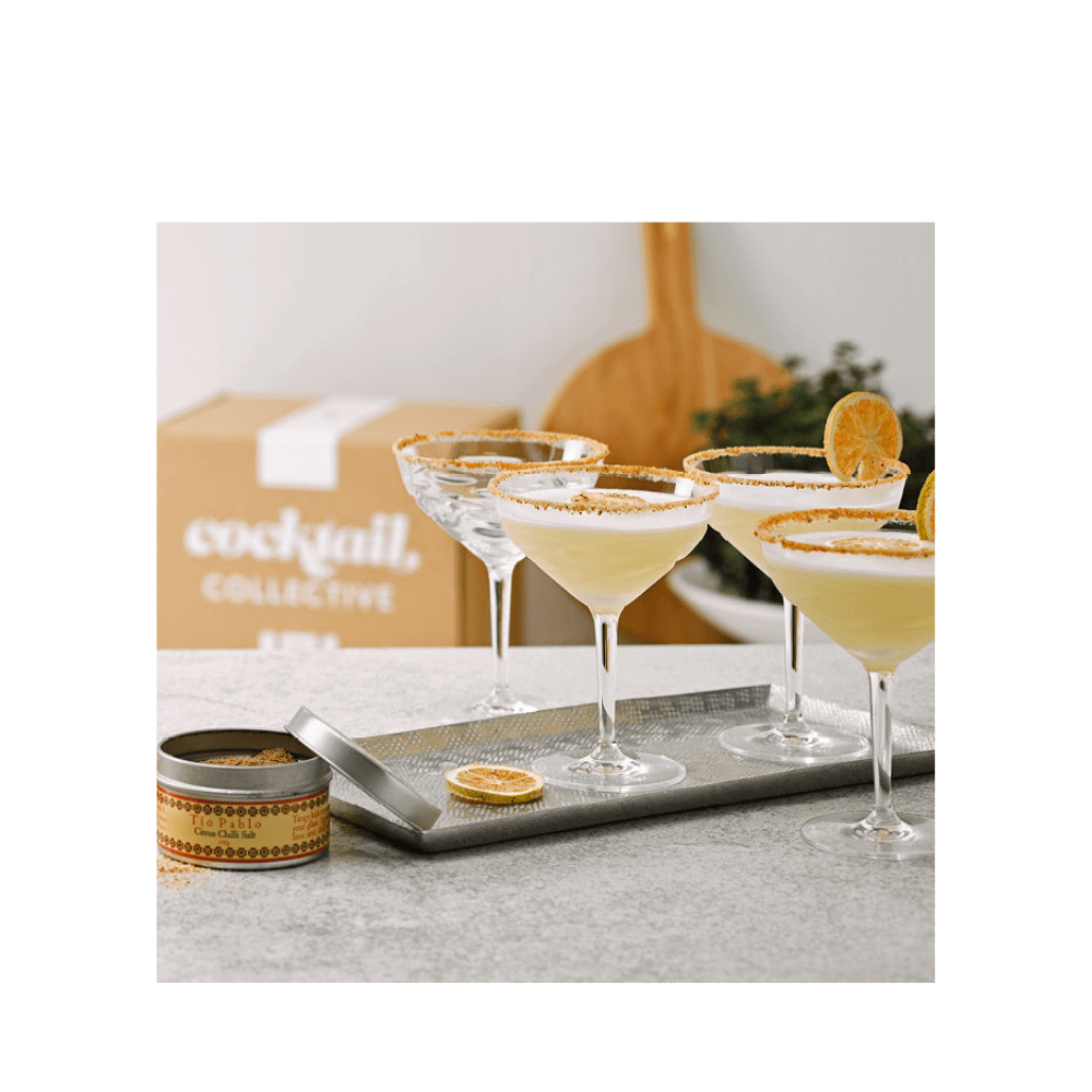 Line up of ingredients in The Margarita Essentials Kit with a pack of Lime Wheel cocktail garnish, Pure Lime Juice, Gomme Syrup & Triple Sec