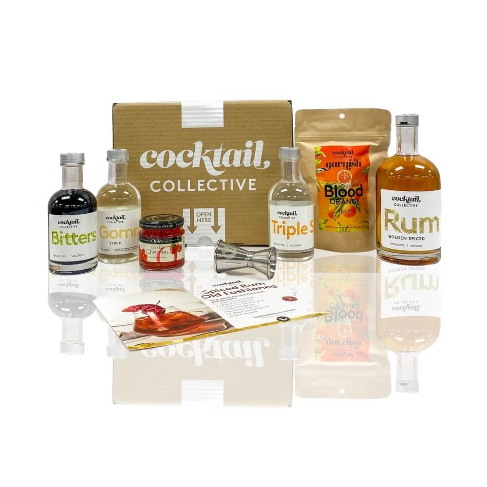 Cocktail Collective's Spiced Rum Old Fashioned garnished with a cocktail cherry and blood orange cocktail garnish.