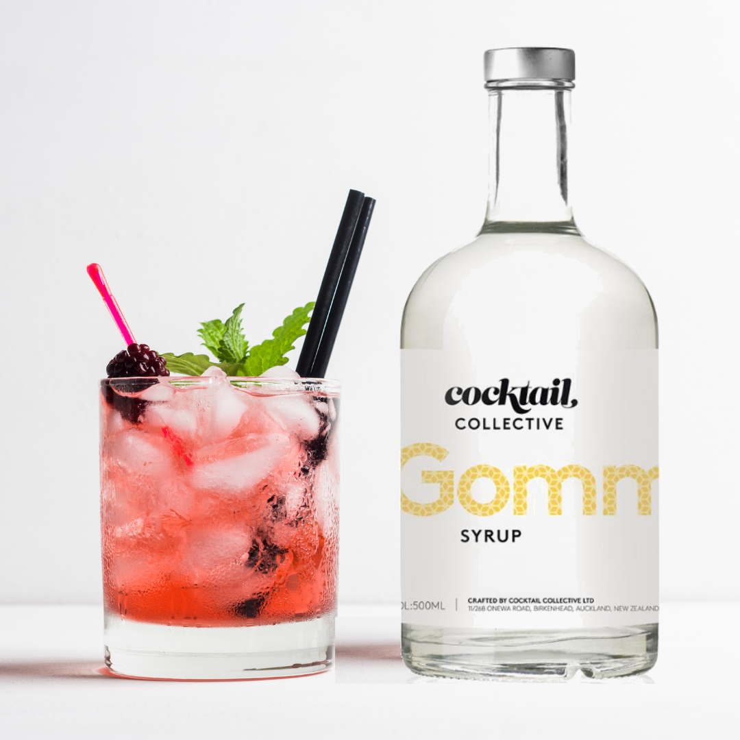 A bottle of Gomme Syrup from Cocktail Collective with a cocktail